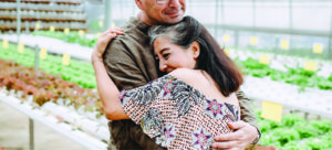 Older couple hugging in market